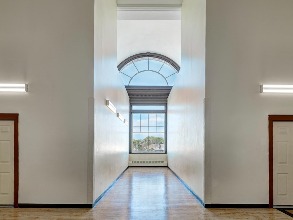 a hallway with an arched ceiling and a window at Chapman House, E. Boston