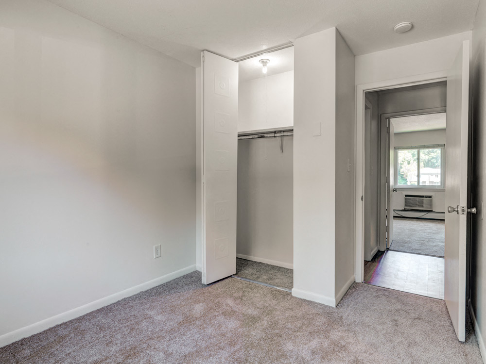Carpeted  Bedroom With Closet at Rolling Green Apartments in Amherst, MA.