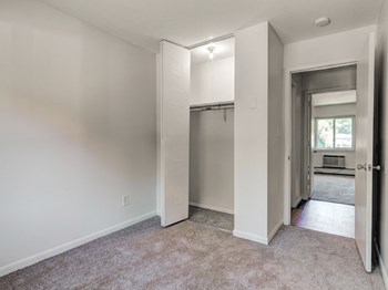 Carpeted  Bedroom With Closet at Rolling Green Apartments in Amherst, MA. - Photo Gallery 10