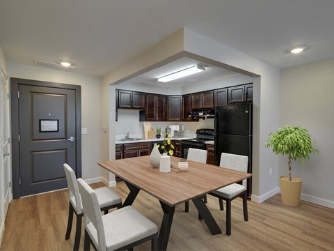 A dining room with a table and chairs.