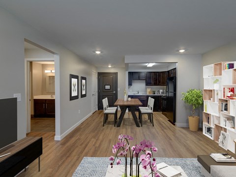 A modern living room with a dining table and chairs.