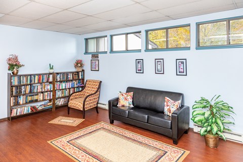 Community Room with Seating and Library at Olympia Place Apartments.