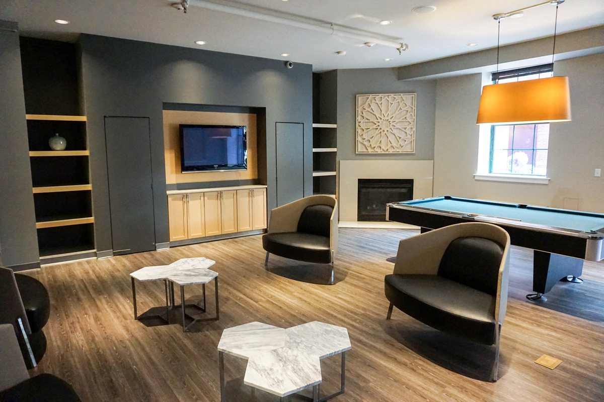 Community Clubhouse With Table And Chairs at The Cordovan at Haverhill Station, Haverhill