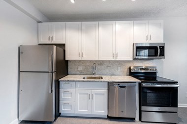 Stainless Steel Kitchen and White Cabinets at Connecticut Plaza Apartments, Washington, District of Columbia.