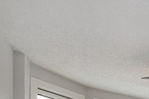 Carpeted bedroom with three windows at Connecticut Plaza Apartments, 2901 Connecticut Ave NW, Washington