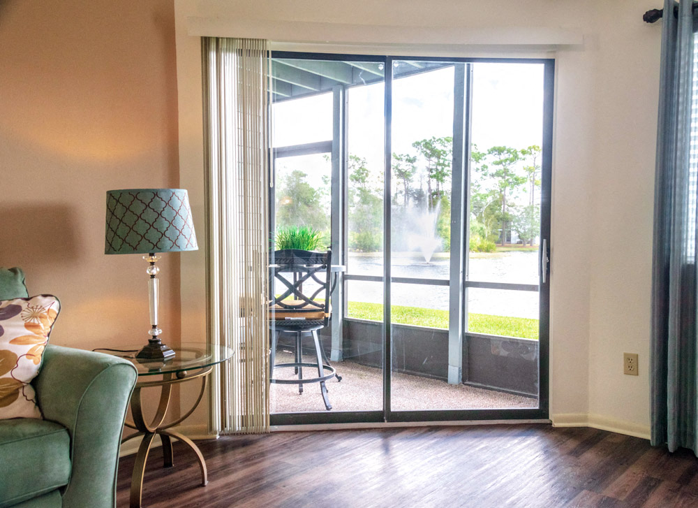 Living Room Looking Over Pond at Fishermans Landing Apartments in Ormond Beach, FL.