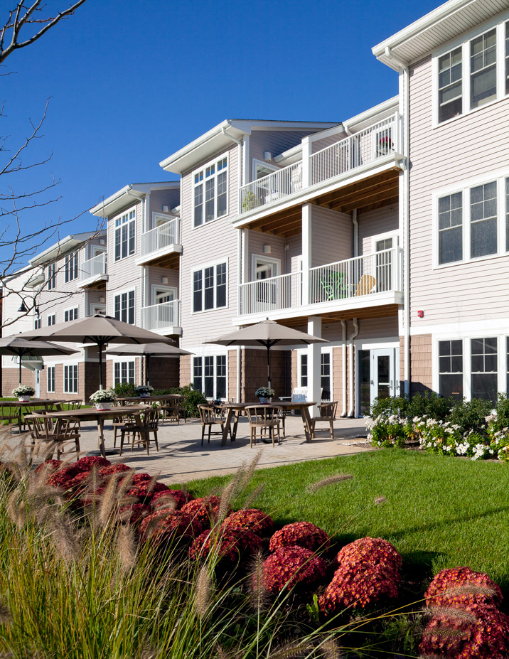Exterior View and Outdoor Patio Seating Area at Ocean Shores Apartments in Marshfield, MA