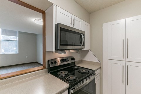 the kitchen of a home with a stove and a microwave