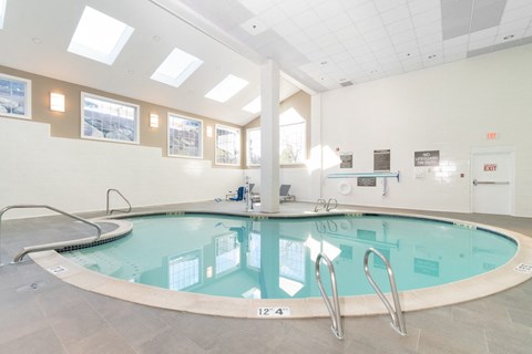 A large indoor swimming pool with a glass bottom. at Ship's Watch Apartments, Fall River, MA, 02720
