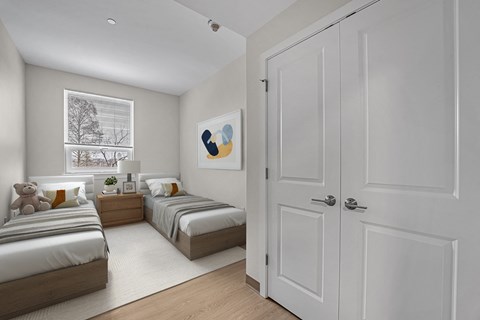 A white bedroom with two beds and a white door.