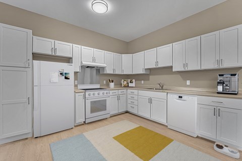 A kitchen with white appliances and cabinets.