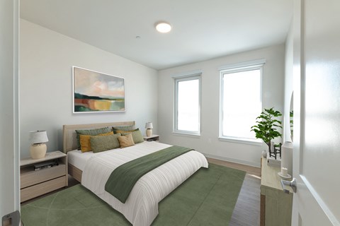 A bedroom with a large bed and a painting on the wall.