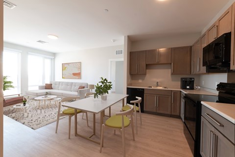 A modern kitchen with a dining table and chairs.