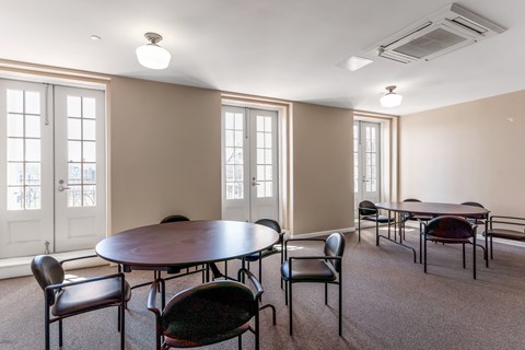 Community room with tables and chairs at 13 State Street, Schenectady NY