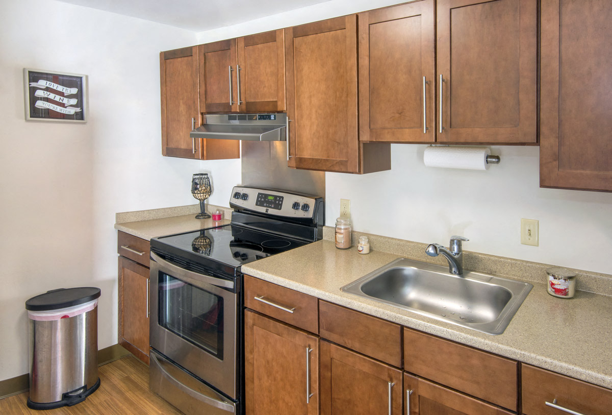 a kitchen with stainless steel appliances and wooden cabinets
