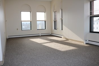 Living Room With Large Windows and Carpet at Pequoig House in Athol, MA. - Photo Gallery 4