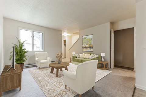 A living room with a white sofa and a wooden coffee table.