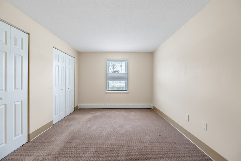 Spacious bedroom with carpet and a window at Blue Hills Village, Canton, MA, 02021