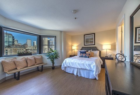 a bedroom with a bed and a large window  at Waterford Place, Massachusetts, 02118