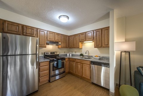 a kitchen with stainless steel appliances and wooden cabinets