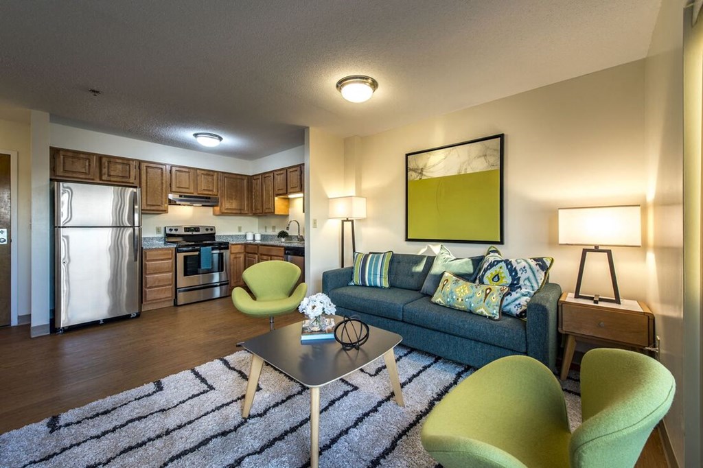 a living room with a couch and a table  at Waterford Place, Massachusetts, 02118