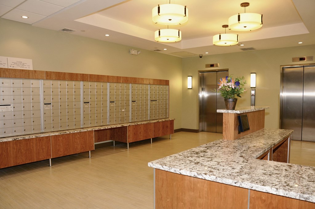 a large lobby with a counter and lockers and a door at Tai Tung Village, Massachusetts