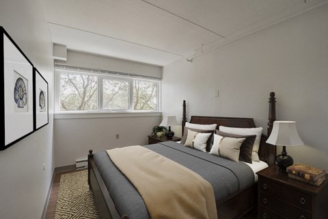 Bedroom with dark wood bed frame at Baystate Place Apartments, Massachusetts, 1104