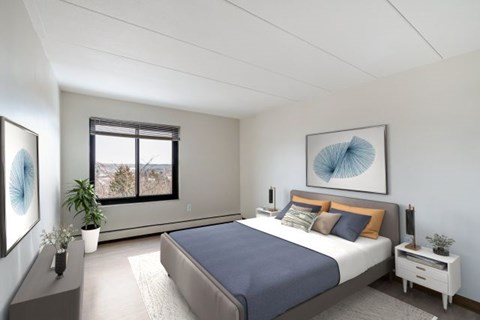 A bedroom with a large bed and a window overlooking a mountainous landscape.