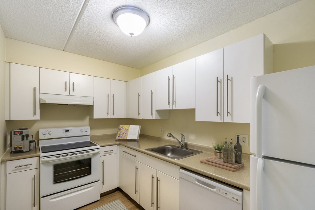 the preserve at ballantyne commons apartment kitchen with white cabinets and appliances at North Stoughton Village, Massachusetts, 02072