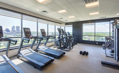 Fitness center with cardio equipment and city views at Baystate Place Apartments, Springfield Massachusetts