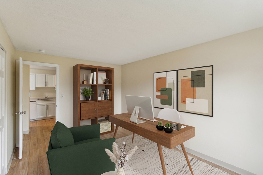 a living room with a desk with a computer and a green couch at North Stoughton Village, Massachusetts