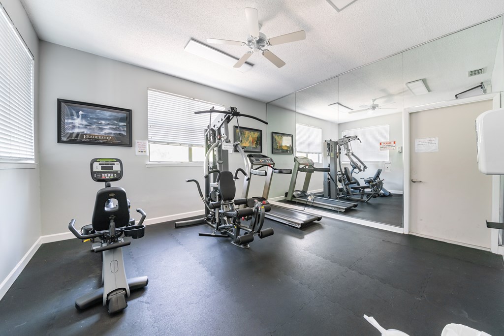 A spacious home gym with a variety of exercise equipment Fishermans Landing Apartments in Ormond Beach, FL.