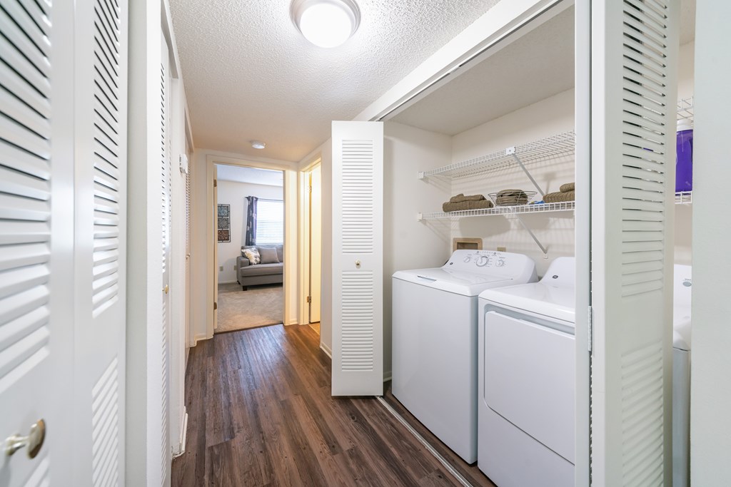 A white laundry room with a washer and dryer Fishermans Landing Apartments in Ormond Beach, FL.