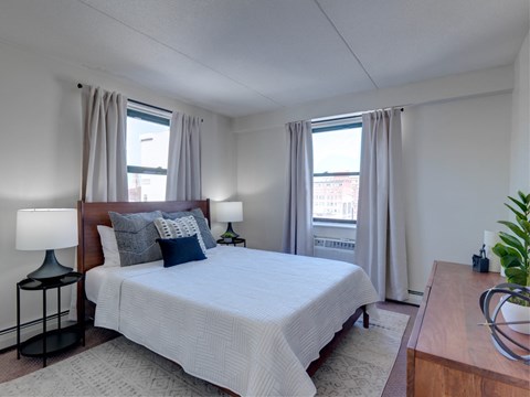 a bedroom with a large bed and two windows at Ninth Square Apartments, Connecticut, 06510