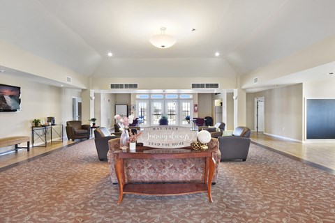 A living room with a couch and a coffee table in the middle.