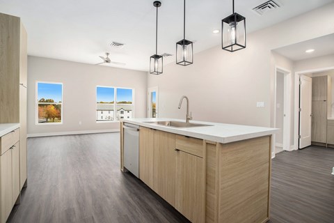 A modern kitchen with wooden cabinets and a white countertop.