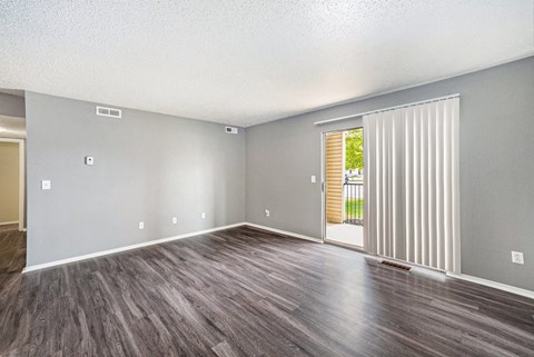 an empty living room with a sliding glass door
