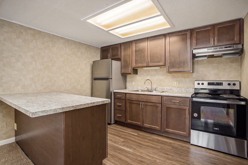 a kitchen with wooden cabinets and stainless steel appliances