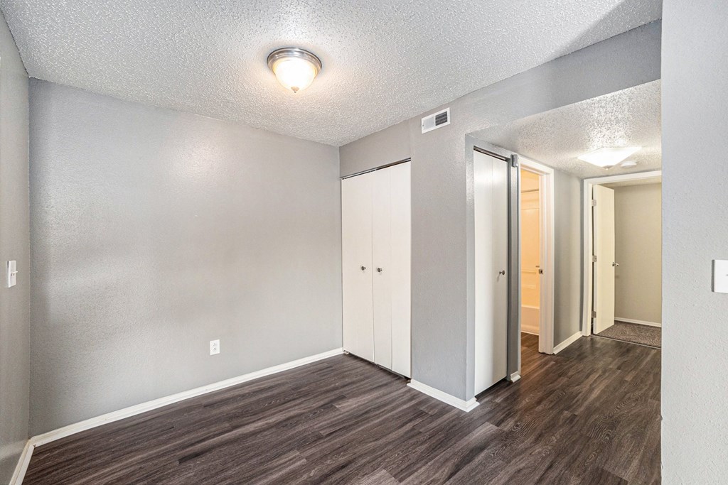 a living room with hardwood floors and grey walls