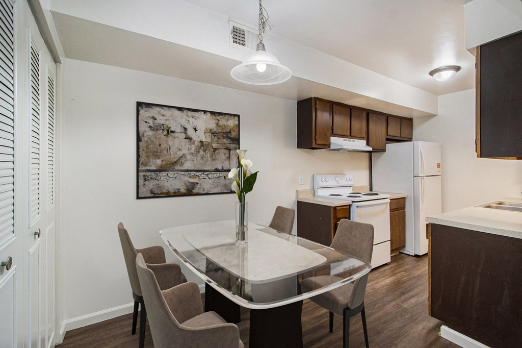 a kitchen and dining room with a table and chairs