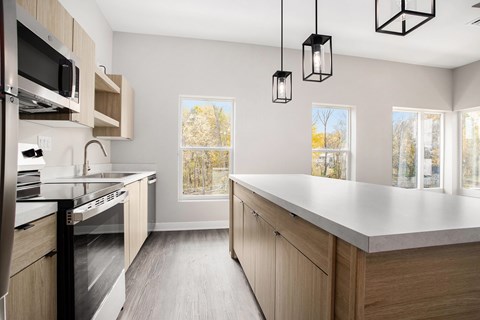 A kitchen with wooden cabinets and a large island.