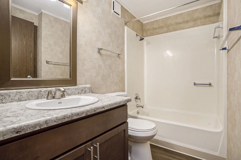 a bathroom with a sink toilet and bathtub