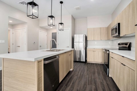 A kitchen with wooden cabinets and a white countertop.