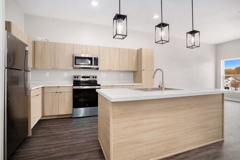 A modern kitchen with wooden cabinets and stainless steel appliances.