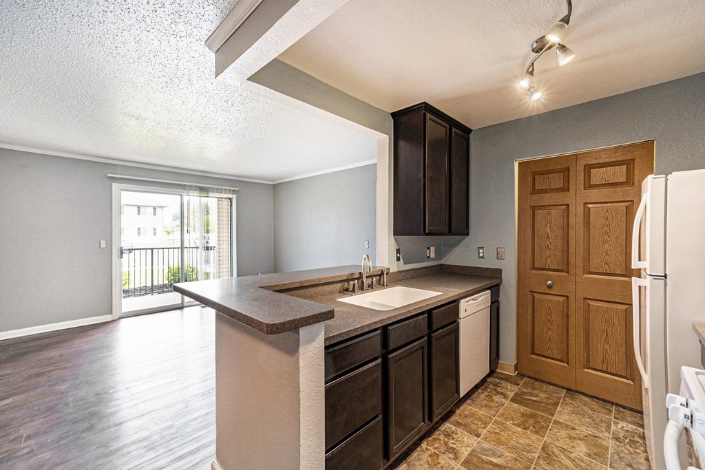 a kitchen with a sink and a refrigerator
