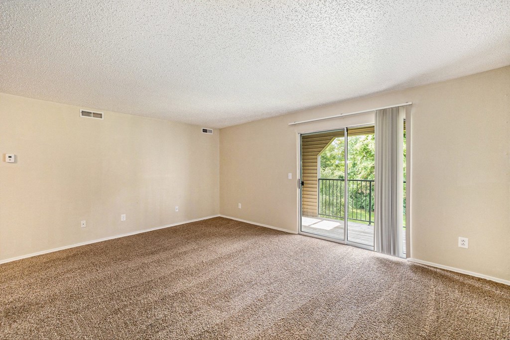 a bedroom with a sliding glass door leading to a balcony