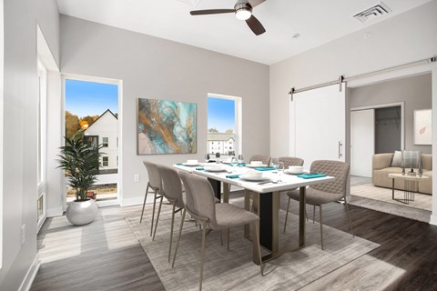A dining room with a table set for six and a potted plant on the floor.