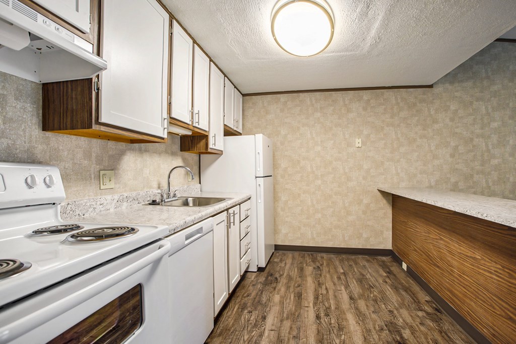 a kitchen with white appliances and white cabinets