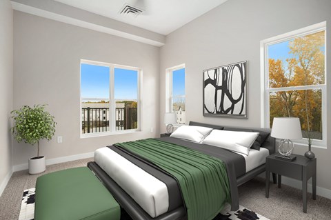 A bedroom with a large bed and a view of the ocean through the windows.