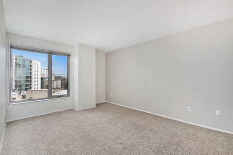 an empty living room with a large window
